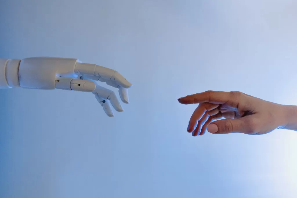 A Anklyticx robot reaching out to a human hand.