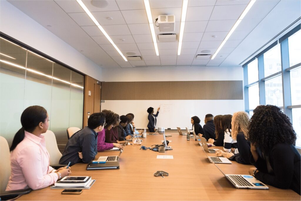 Anklyticx - A group of people sitting around a conference table.