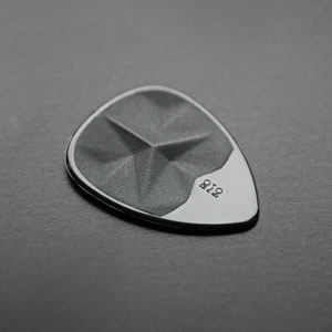 Anklyticx - A black guitar pick on a black surface.