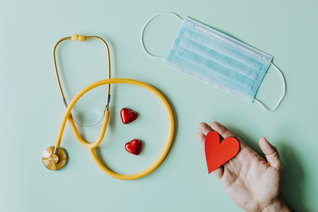 Anklyticx - Stethoscope, red heart, medical mask and stethoscope on a green background.