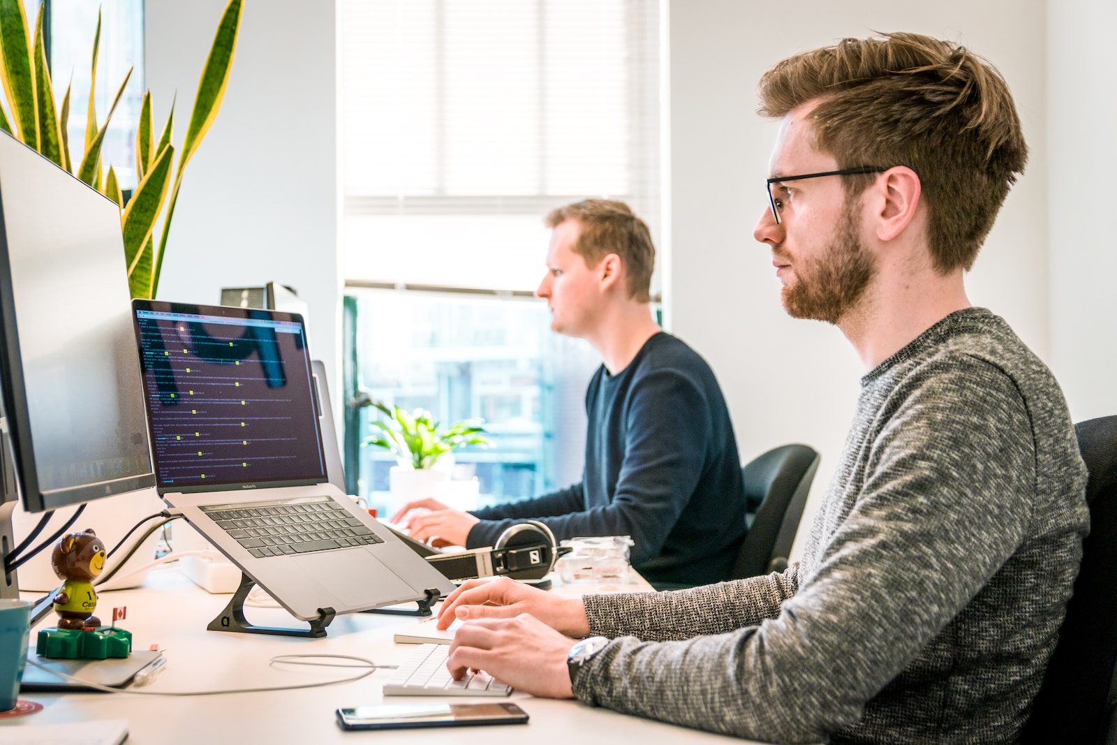 Anklyticx - Two men working on computers in an office.